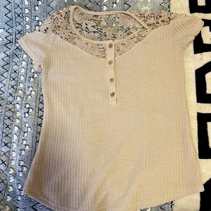 Half button up Light tan/nude waffle top with flowery lace design around collar